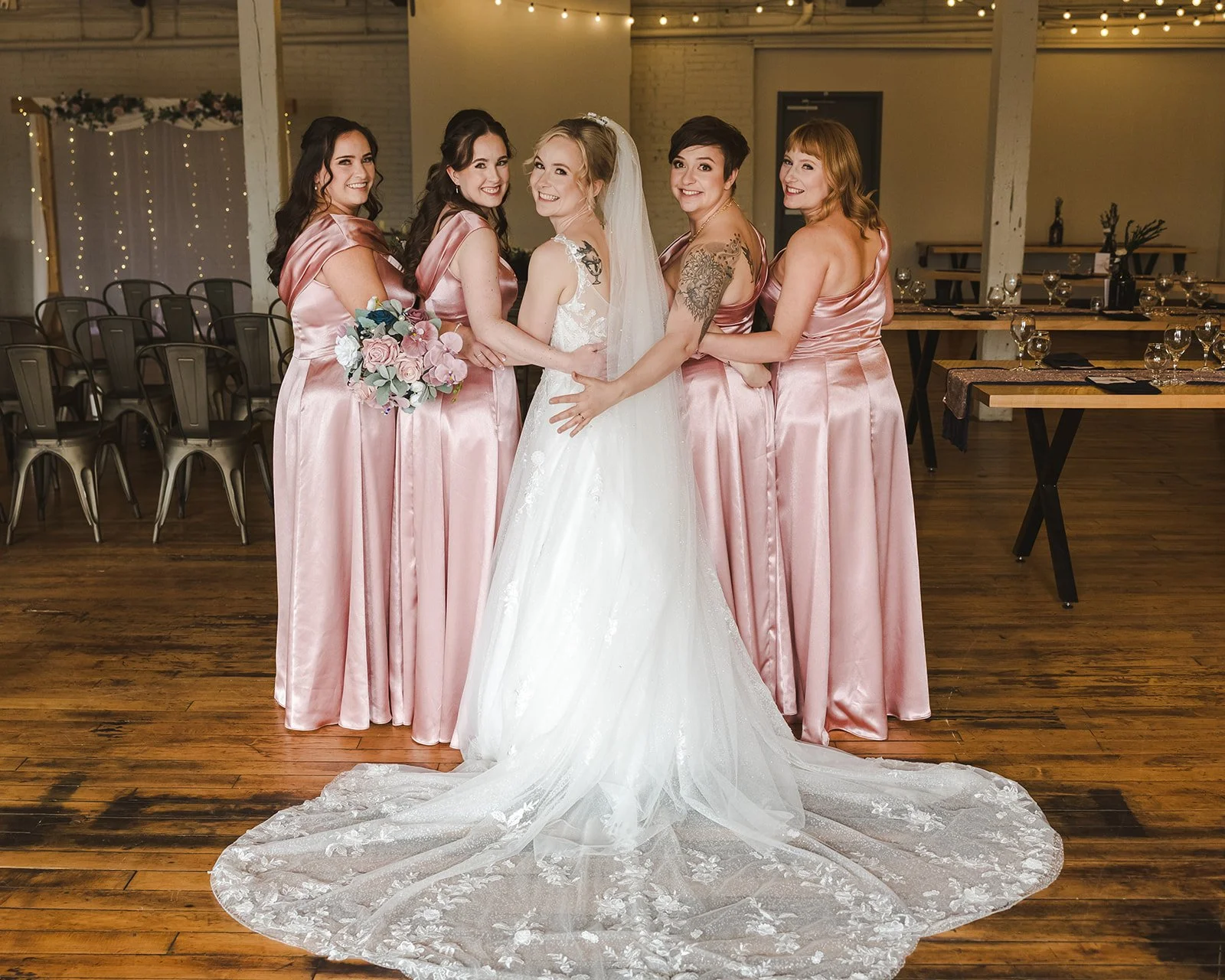 Bride looking back over shoulder with bridesmaids  Four Fathers  Cambridge, ON  Fedora Media.jpg