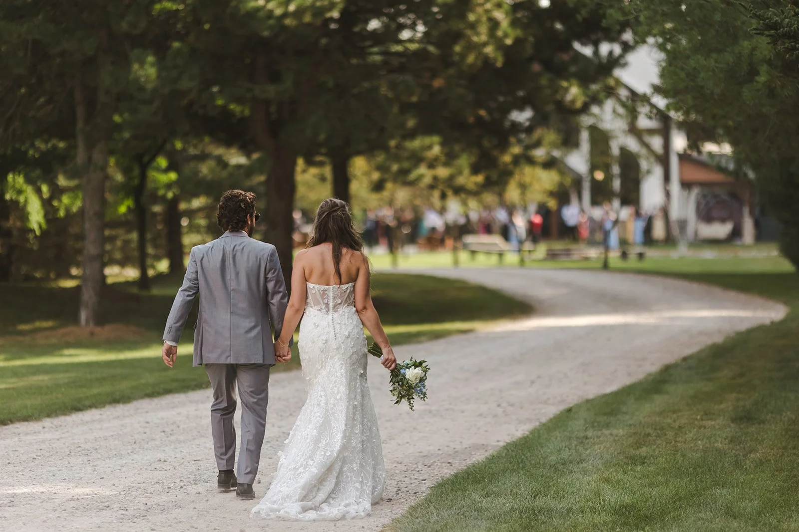 Bride and groom walking up to venue hand in hand  Erin Estates  Fedora Media.jpg