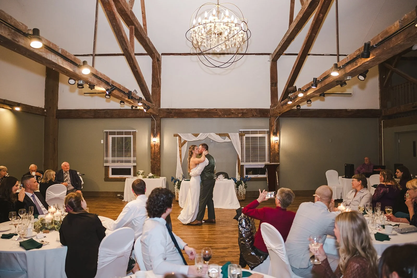 Bride and groom kiss during first dance  fall wedding  Fedora Media.jpg