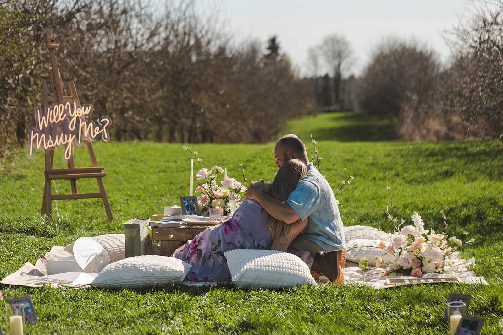 Couple sitting at propsal picnic  Orchard Propsal  Fedora Media.jpg