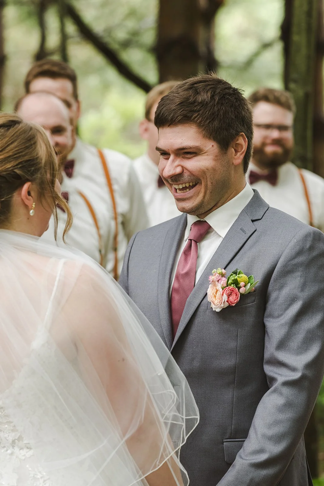 Groom laughing during wedding ceremony  Boho Wedding  Fedora Media.jpg