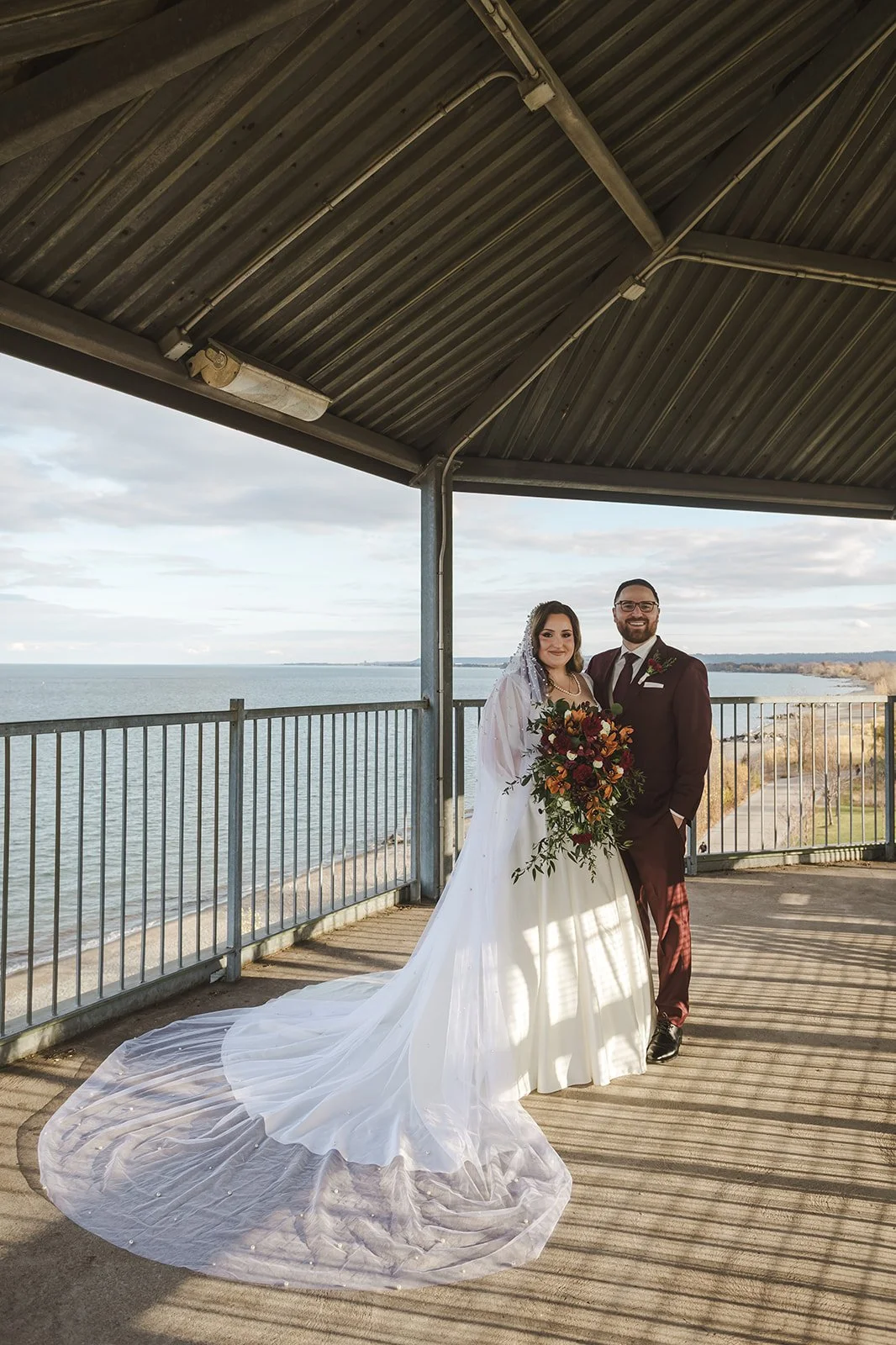 Bride and groom in pergola  Lakeview By Carmens  Hamilton, ON  Fedora Media.jpg