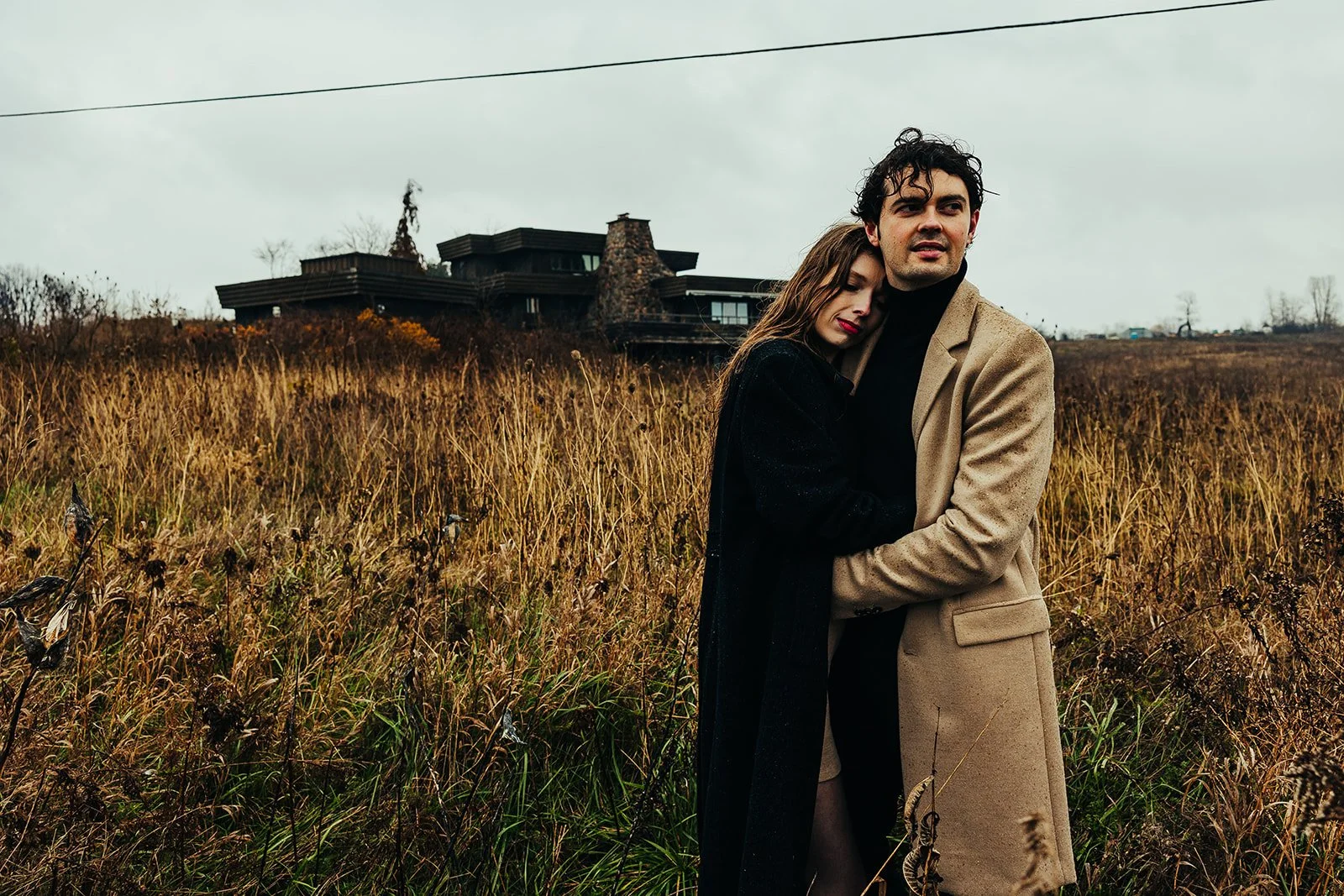 Women embracing man in rainy field  Fedora Media.jpg