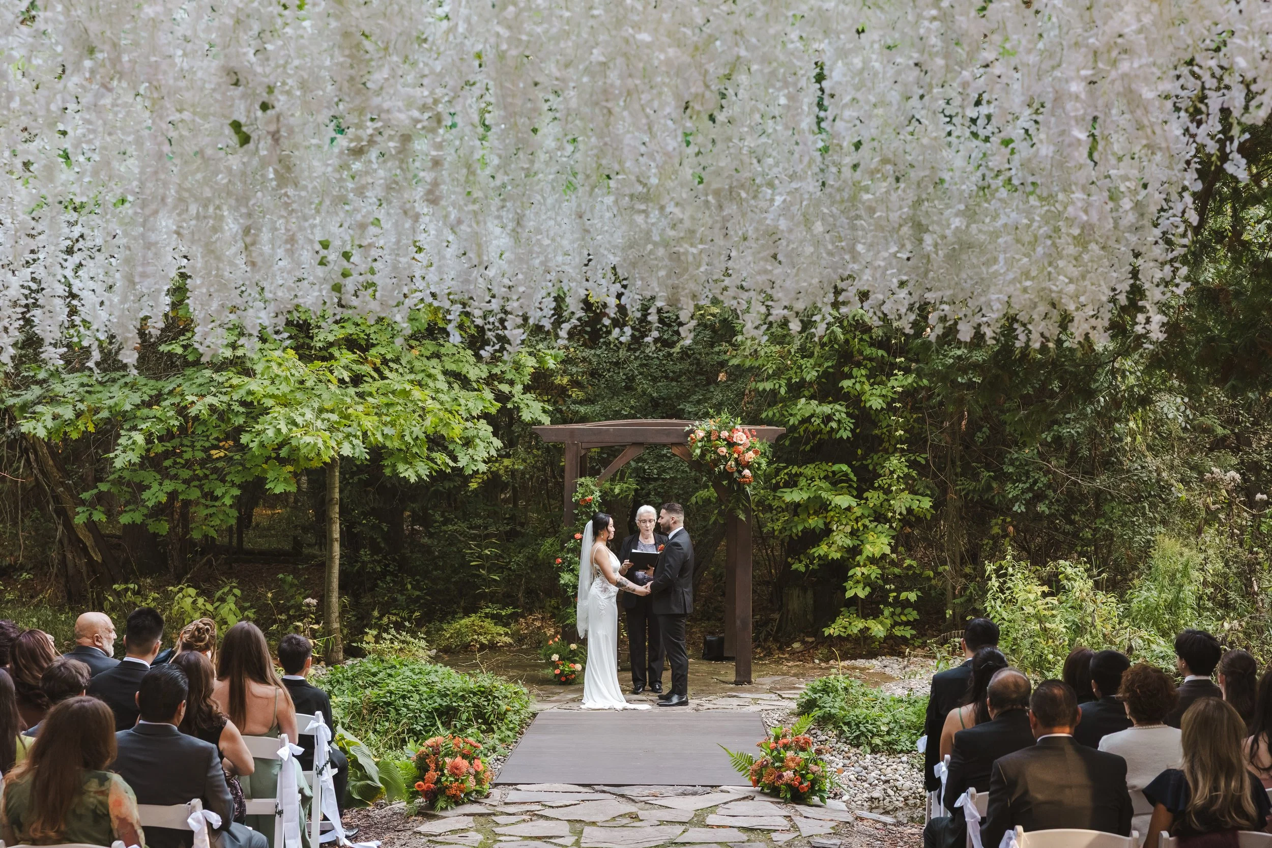couple-under-hanging-flowers-outdoors-fedora-media.jpg