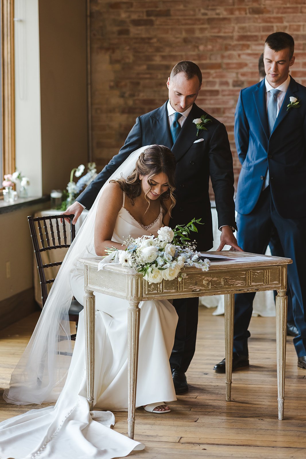 Bride signing wedding certificate  River's Edge  Arlington Hotel  Paris, ON  Fedora Media.jpg