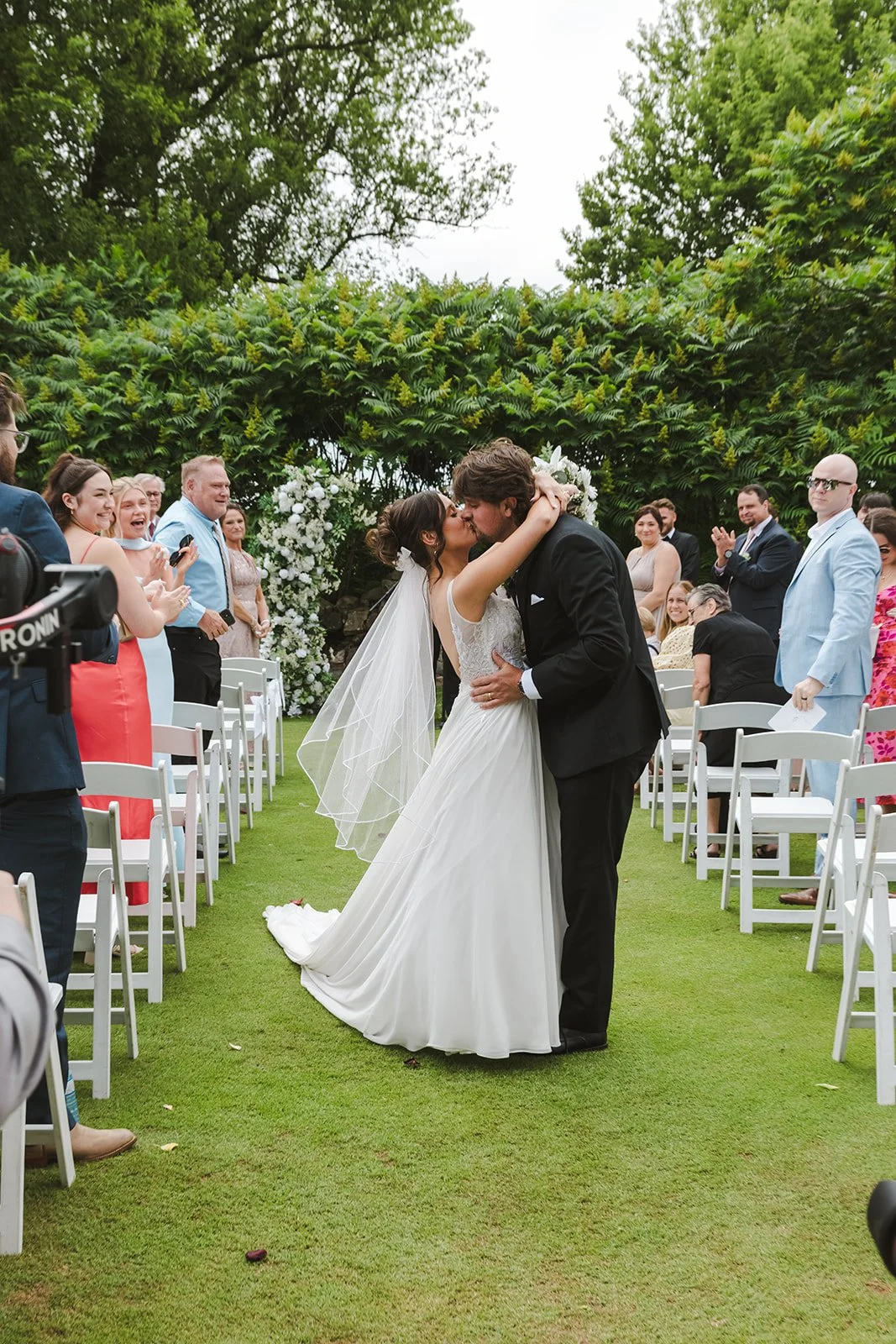 Bride and groom kiss in wedding aisle  Rebel Creek  Fedora Media.jpg