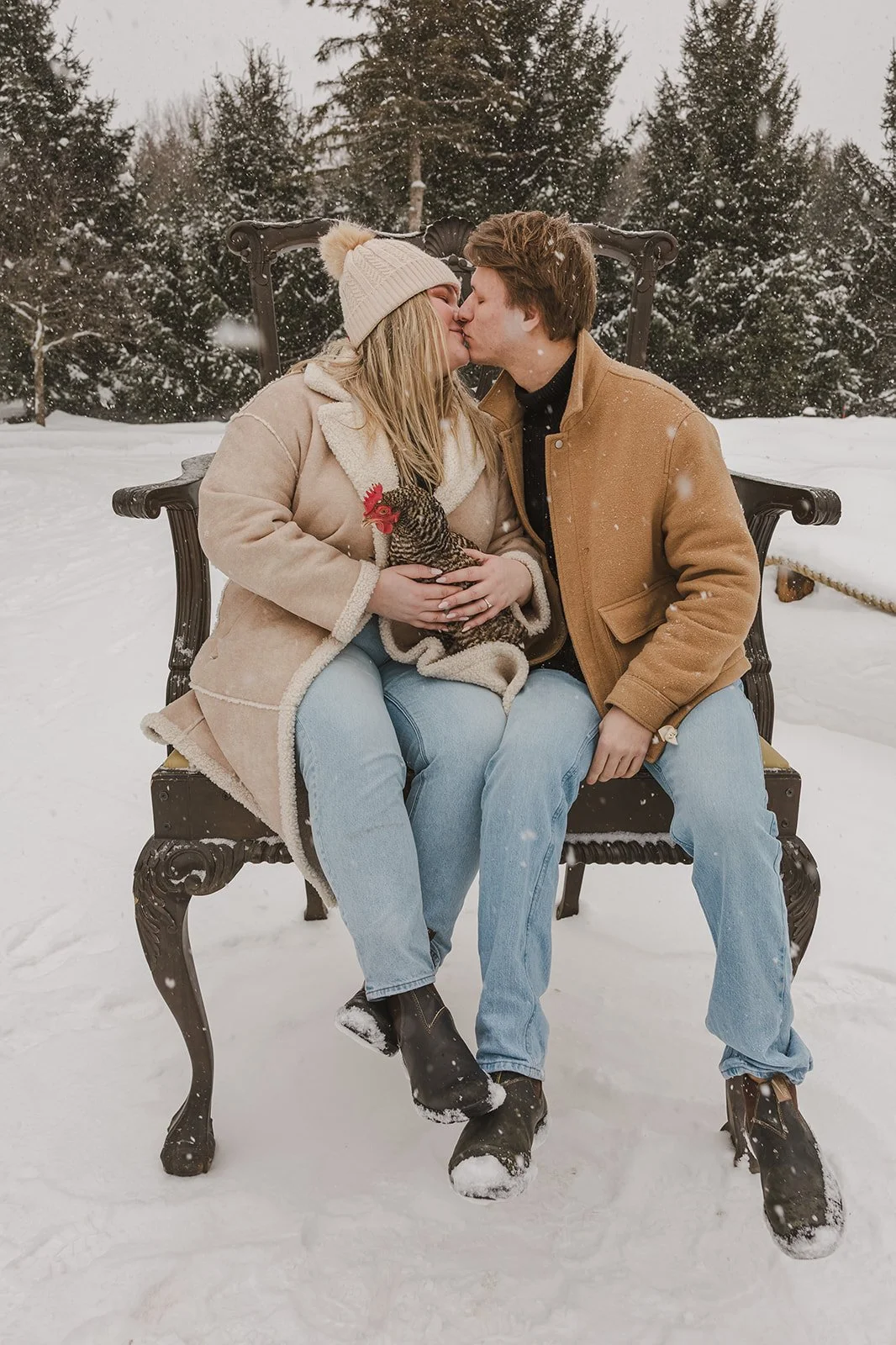 Couple sitting in snow with chicken  Ontario Engagement  Fedora Media.jpg