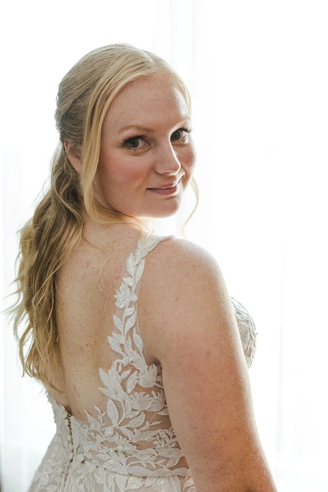 Bride Smiling Over Her Shoulder in Wedding Dress  Cambridge, ON  Fedora Media.jpg
