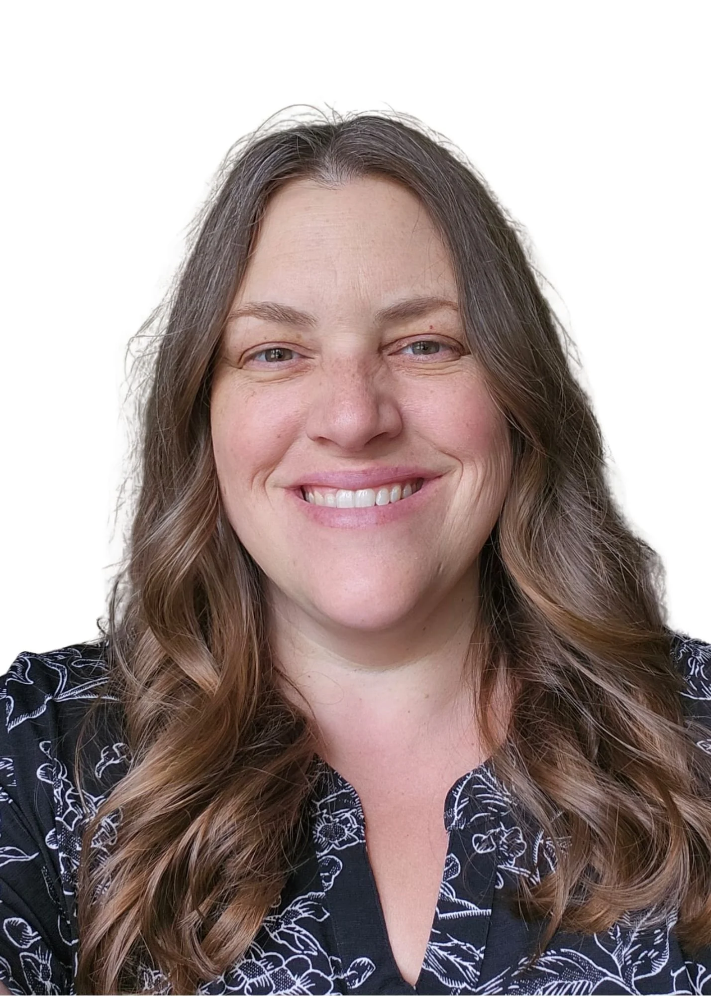 A woman with long brown hair smiling against a white background