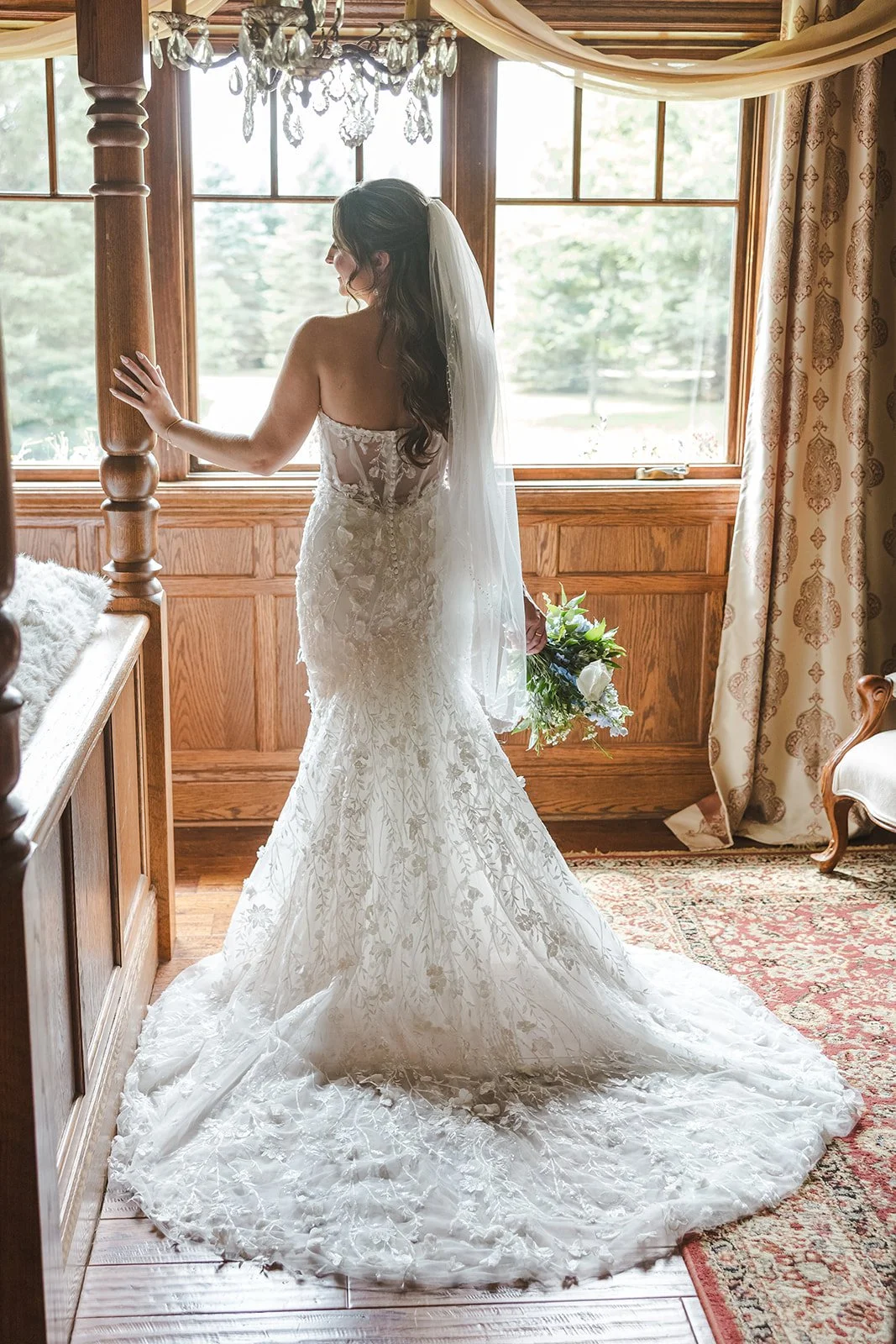 Bride in bridal suit.e looking out window  Erin Estates  Fedora Media.jpg