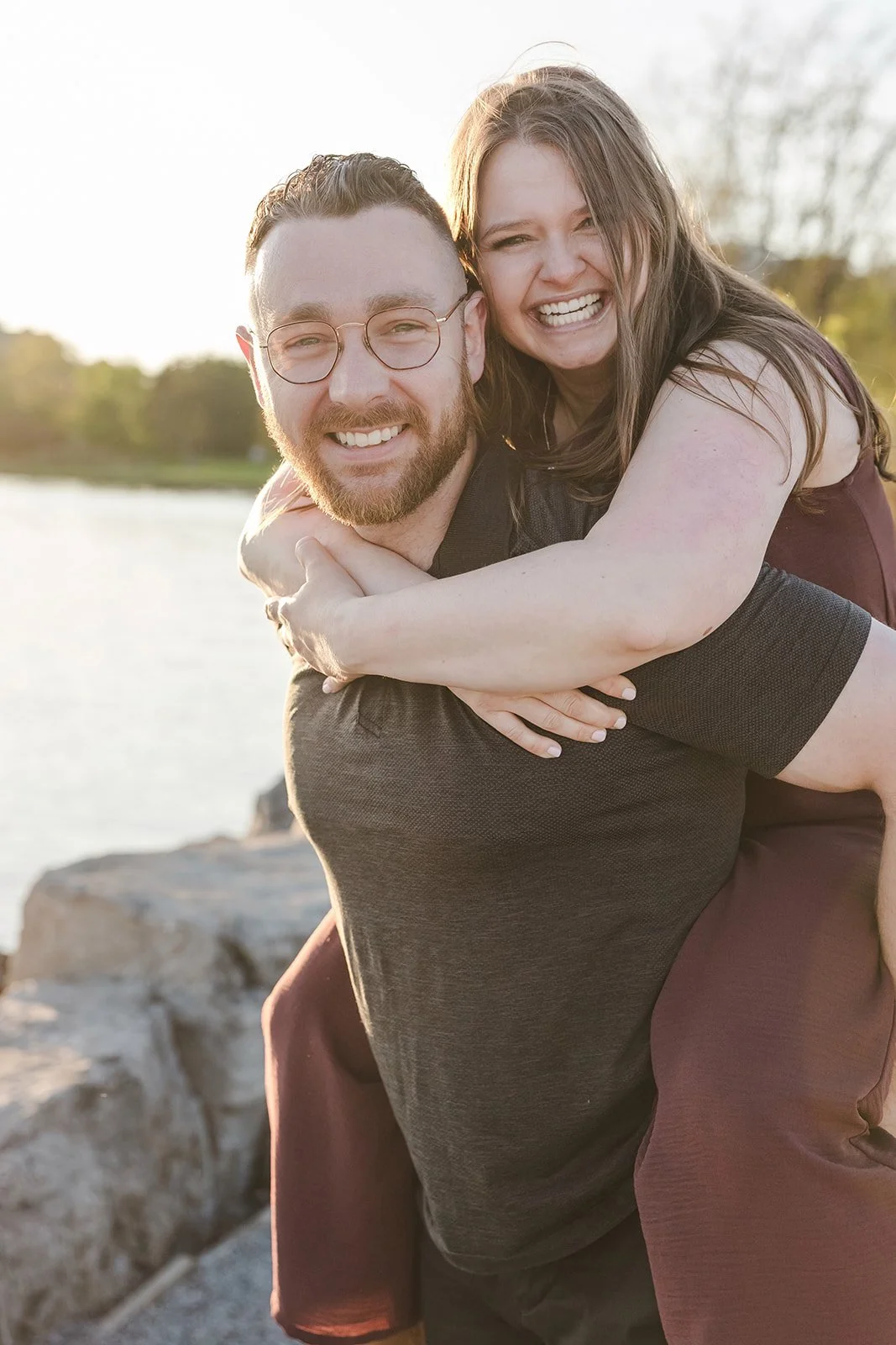 Couple smiling during piggback ride  Ontario Engagement  Fedora Media.jpg