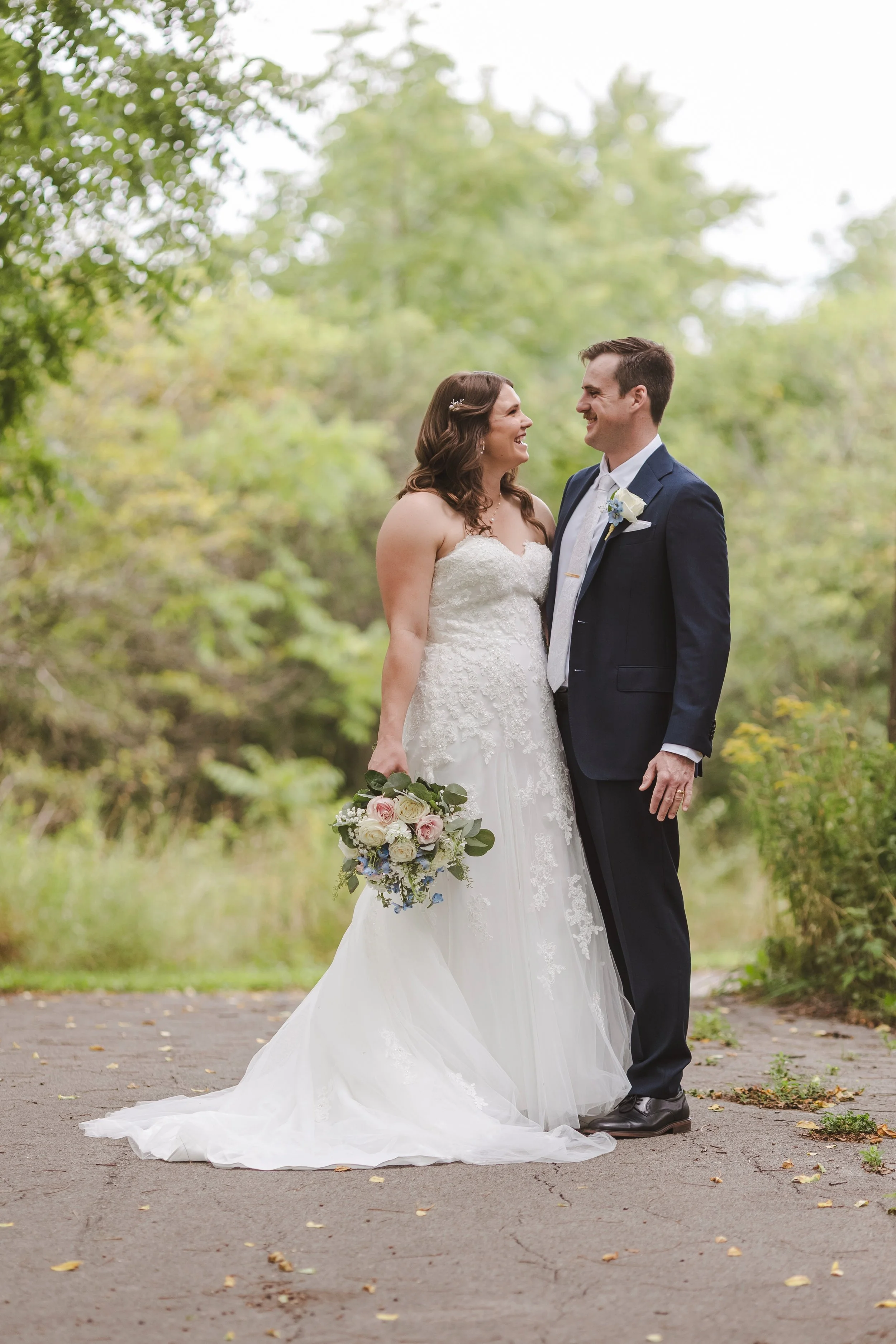 couple-standing-outdoors-in-wedding-attire-fedora-media.jpg