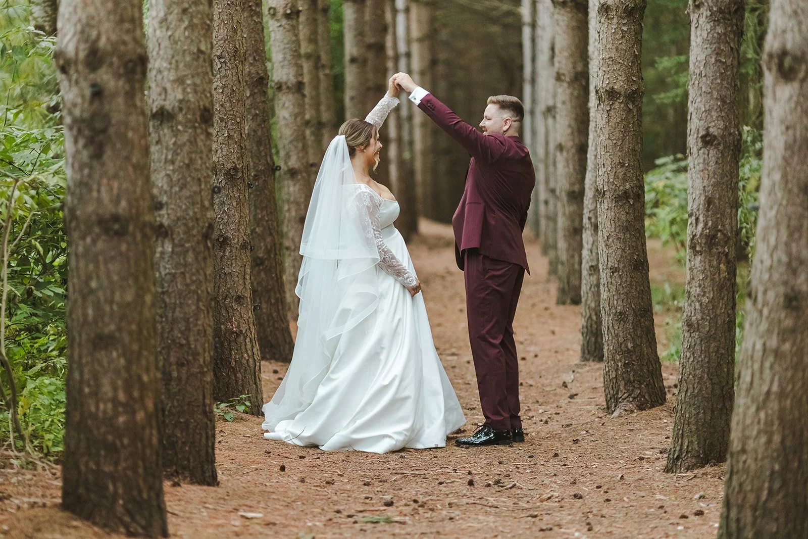 Groom spinning bride on forest trail  Erin Estates  Fedora Media.jpg