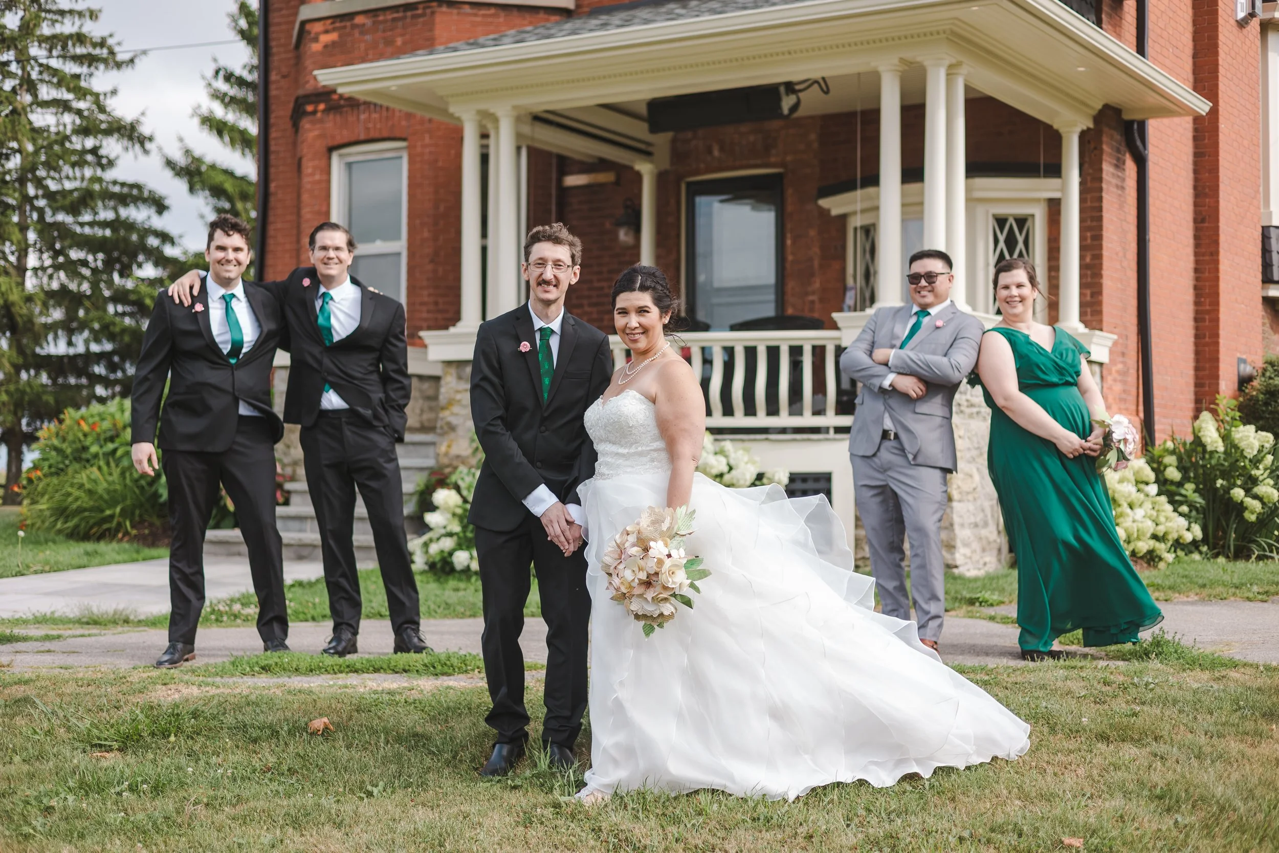 bride-and-groom-with-people-in-front-of-a-porch-fedora-media.jpg