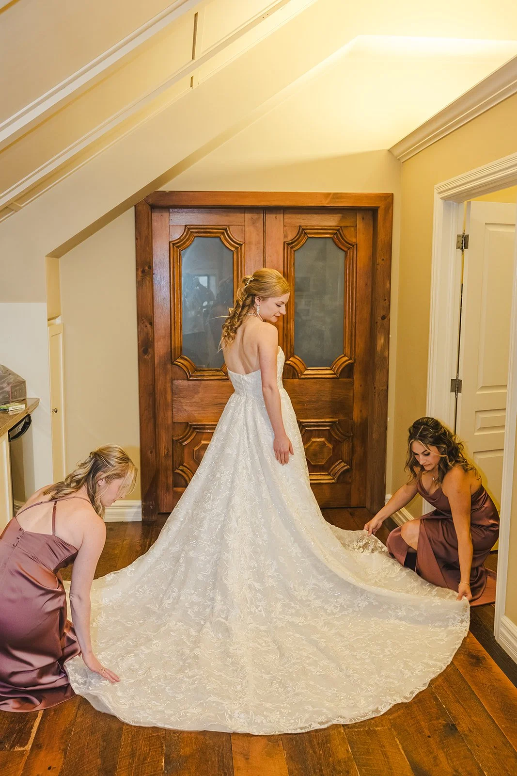 Bridesmaids adjusting bride's dress  Ancaster,  ON  Ancaster Mill  Fedora Media.jpg