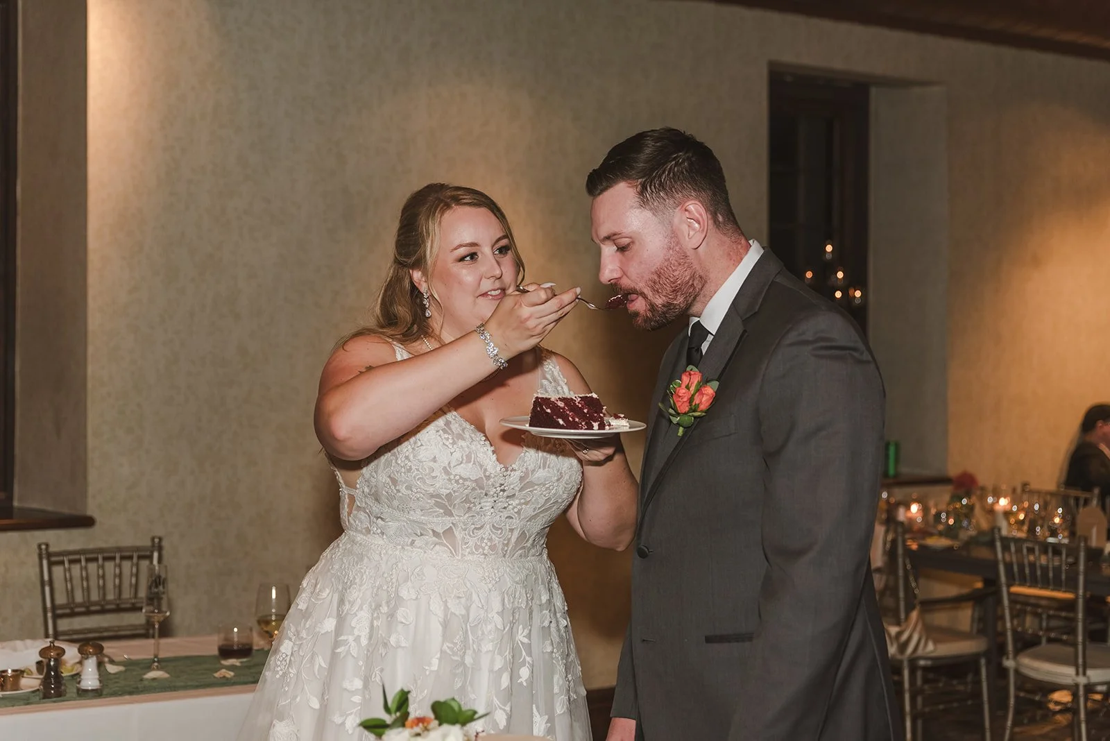 Bride feeding wedding cake to groom  Ancaster,  ON  Ancaster Mill  Fedora Media.jpg
