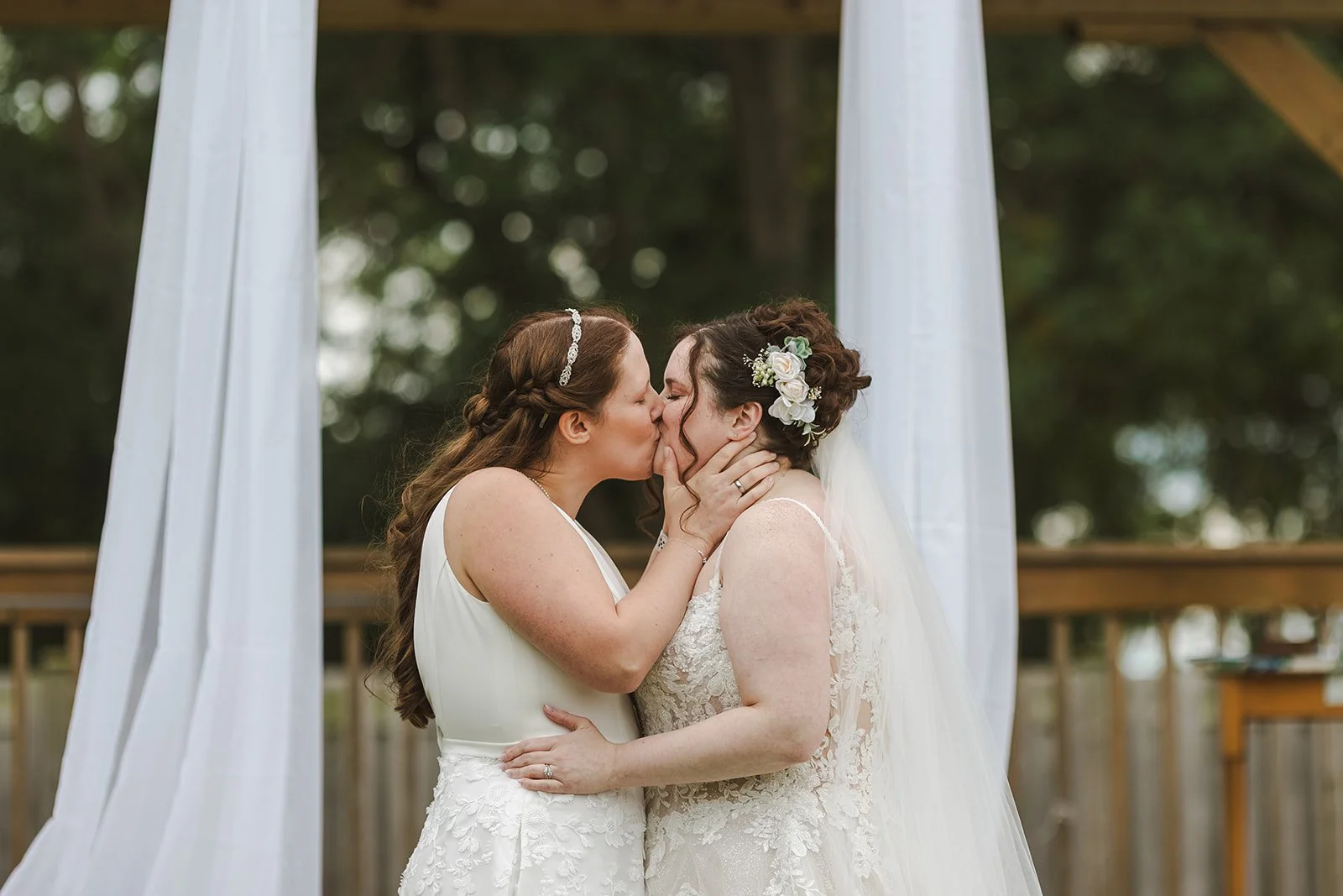 Brides sharing first kiss  Newfoundland Club  Cambridge, ON  Fedora Media.jpg