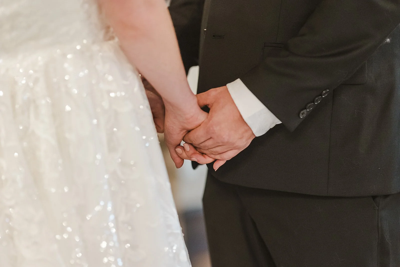 Bride and groom holding hands during wedding ceremony  Ancaster,  ON  Ancaster Mill  Fedora Media.jpg