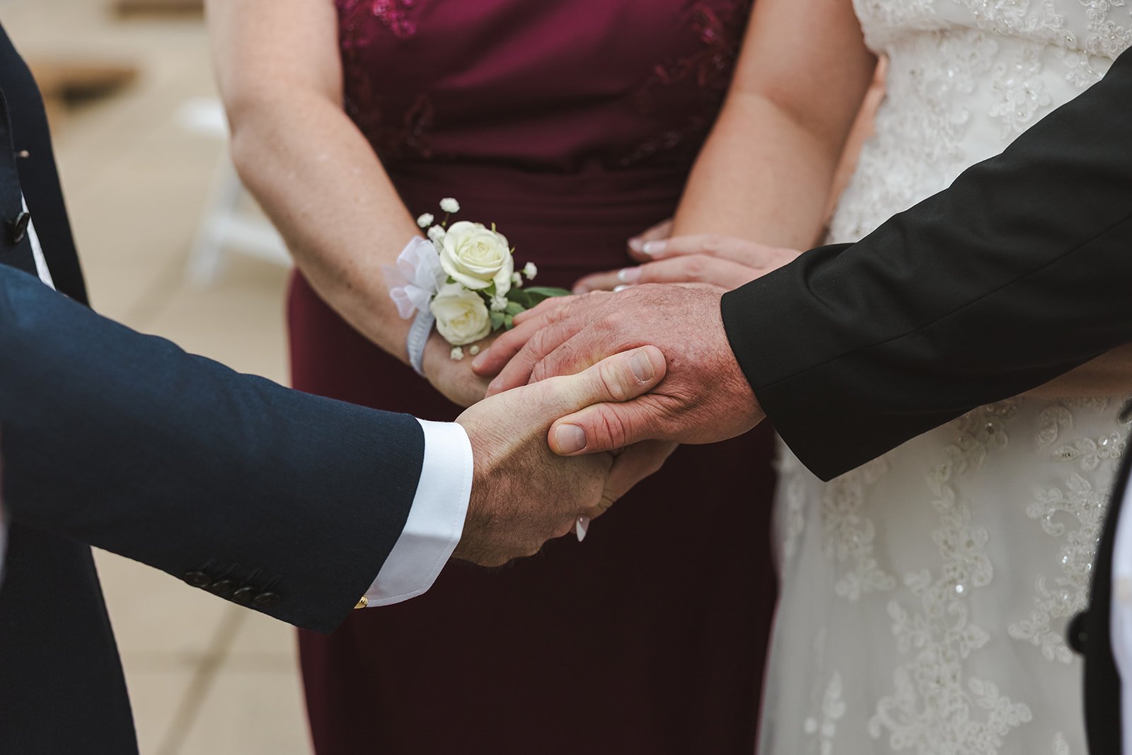 Holding hands during prayer in wedding ceremony  Carmen's Hotel  Hamilton, ON  Fedora Media.jpg