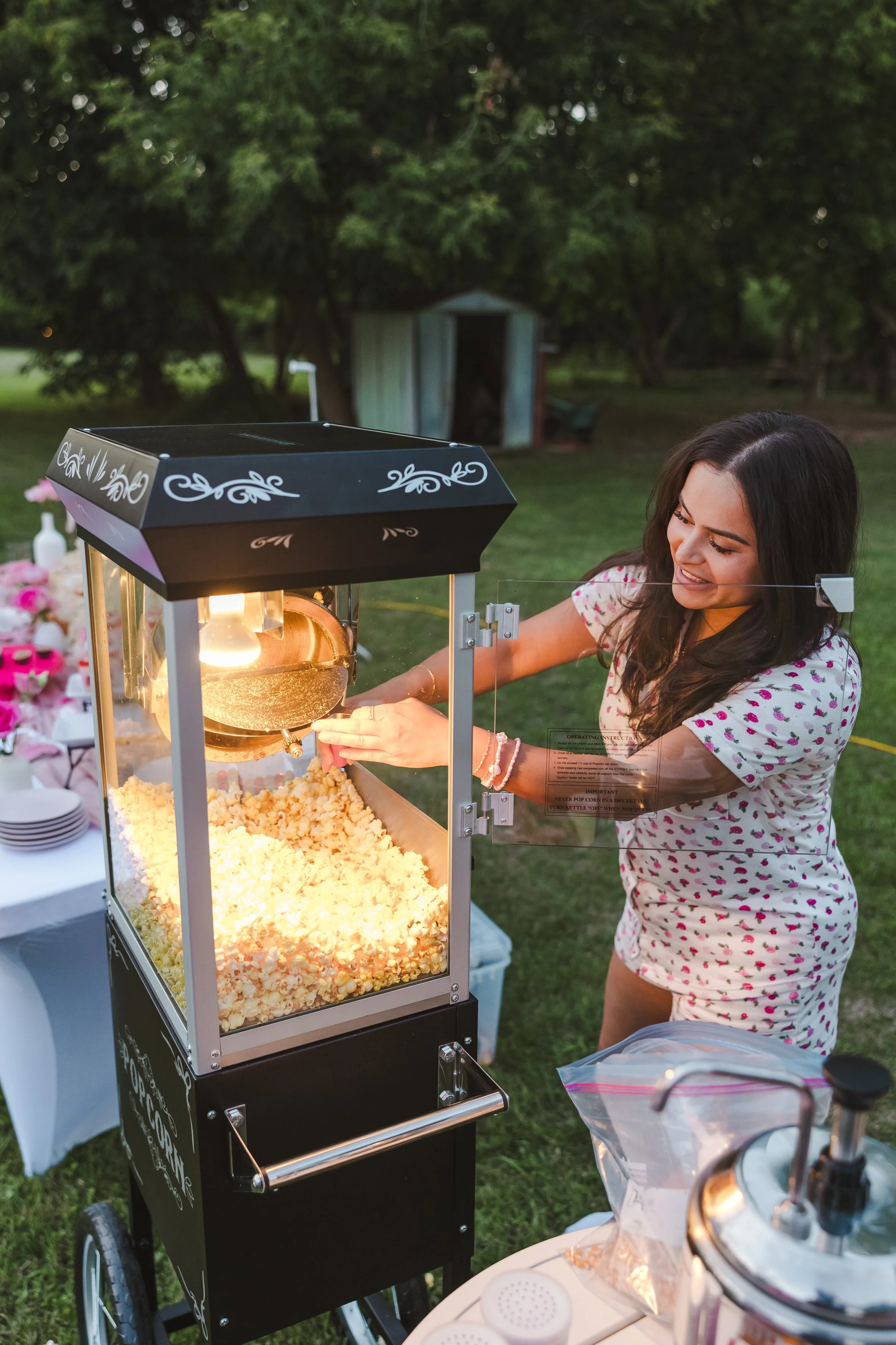 woman-in-pajamas-scooping-popcorn-from-popcornpopper-movie-night-fedora-media.jpg