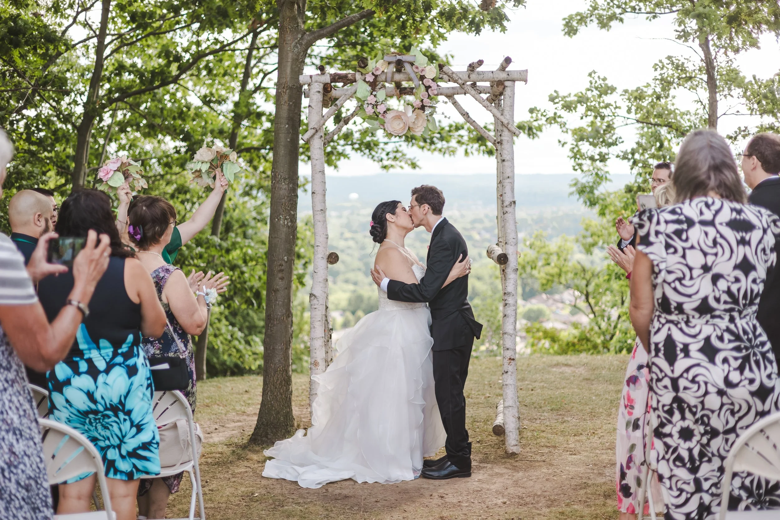 bride-groom-under-a-wooden-arch-fedora-media.jpg