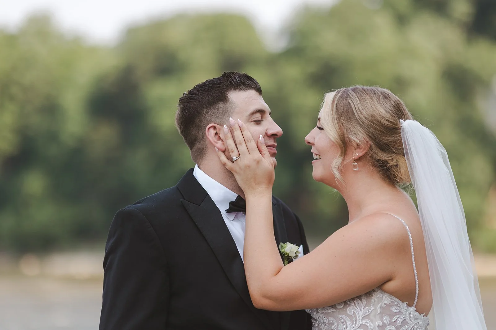 Bride holding groom's face  Arlington Hotel  River's Edge  Paris, ON  Fedora media.jpg