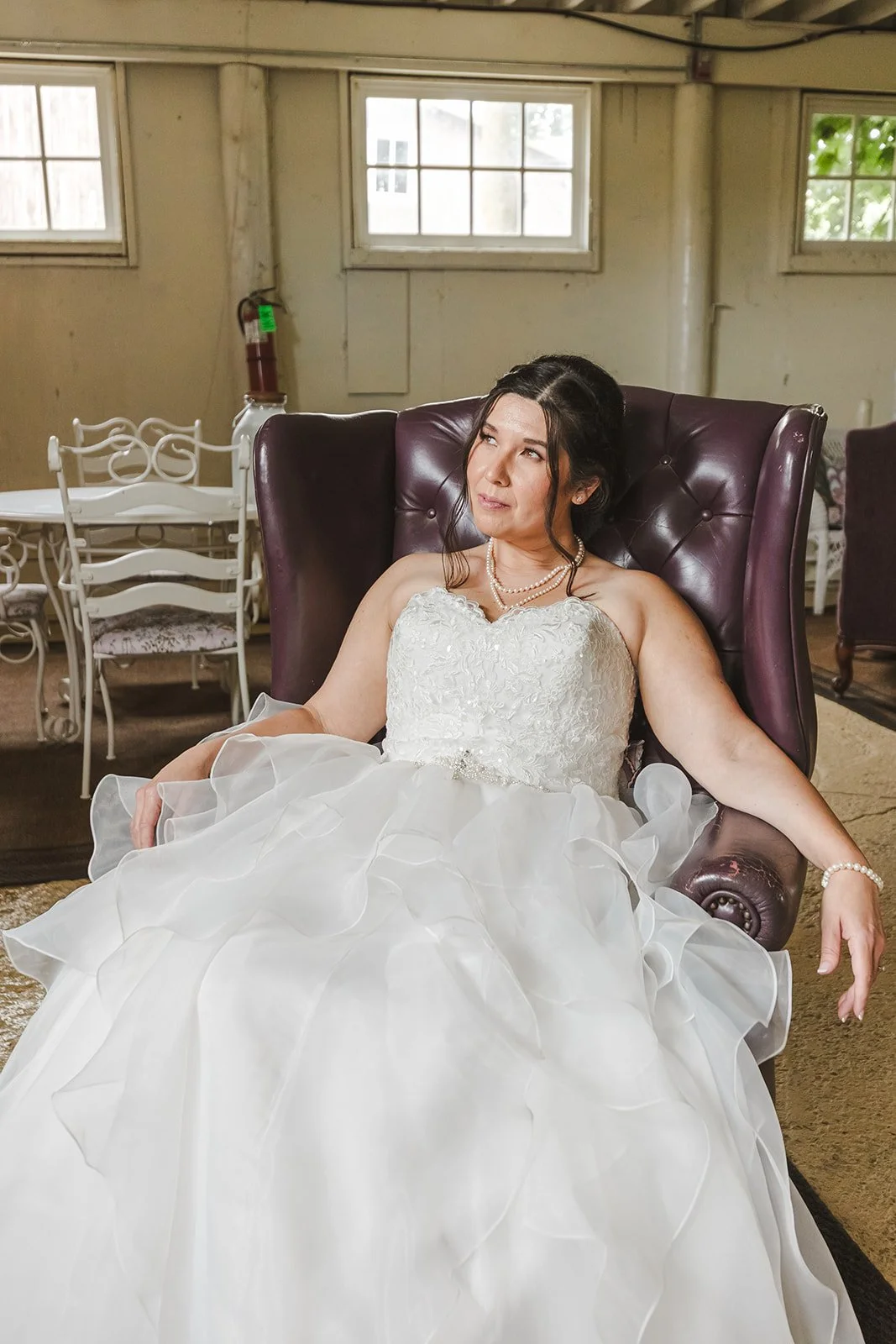 Bride sitting in leather chair  Hamilton, ON  Glen Drummond Farm  Fedora Media.jpg
