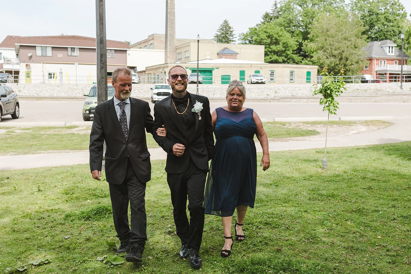 Groom walking down wedding aisle with parents  Puddicombe House  New Hamberg, ON  Fedora Media.jpg