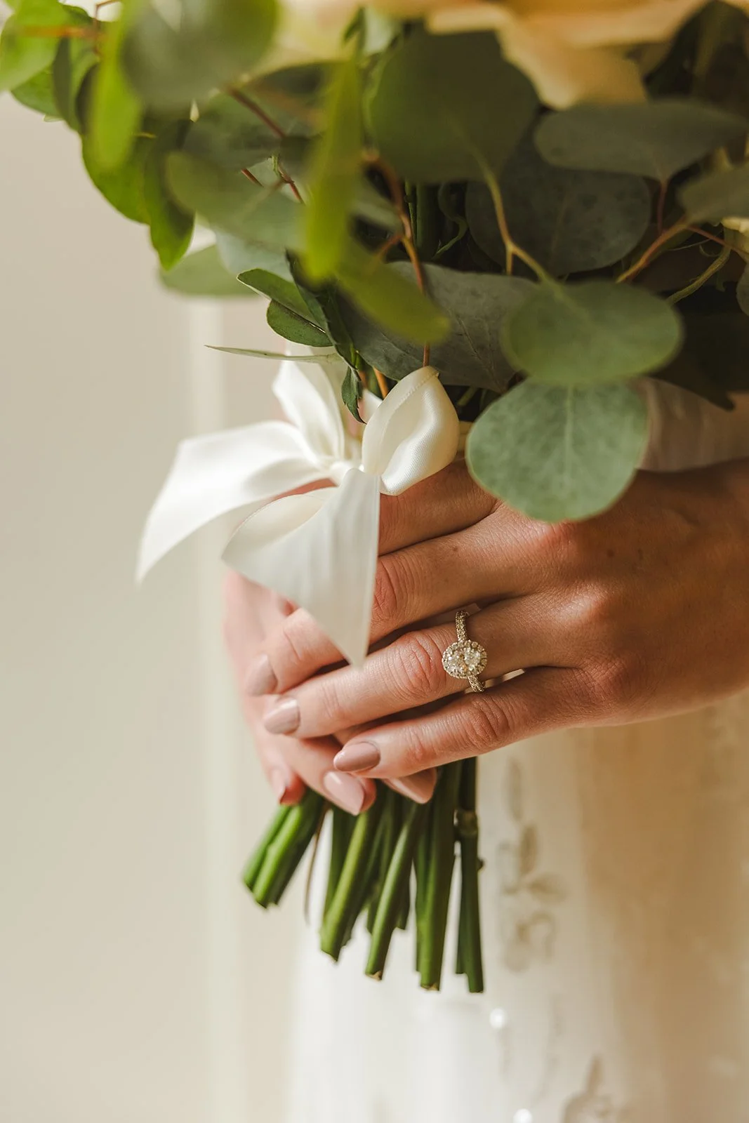 Bride holding bouquet with engagement ring  Ancaster,  ON  Ancaster Mill  Fedora Media.jpg