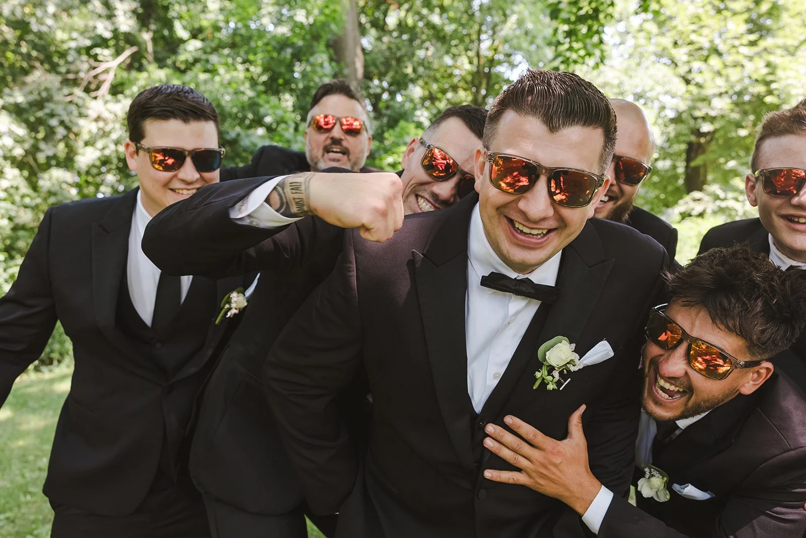 Groom in sunglasses having fun with groomsmen  Arlington Hotel  River's Edge  Paris, ON  Fedora media.jpg