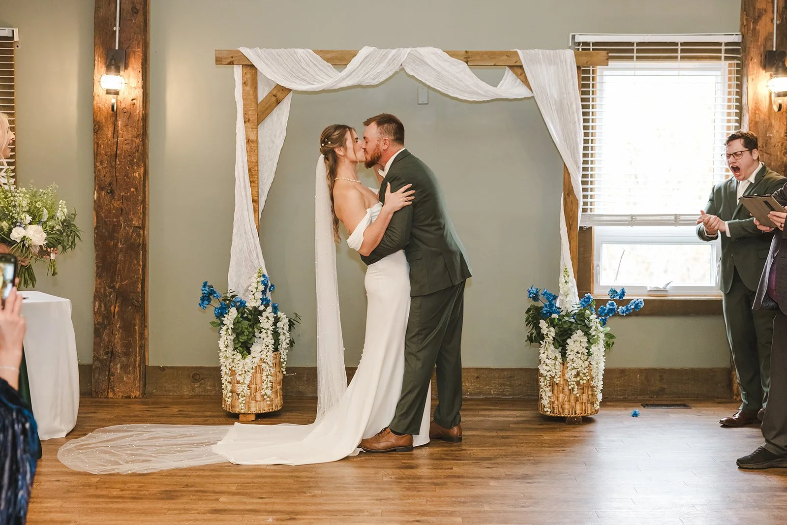 Bride and groom first kiss during wedding ceremony  fall wedding  Fedora Media.jpg