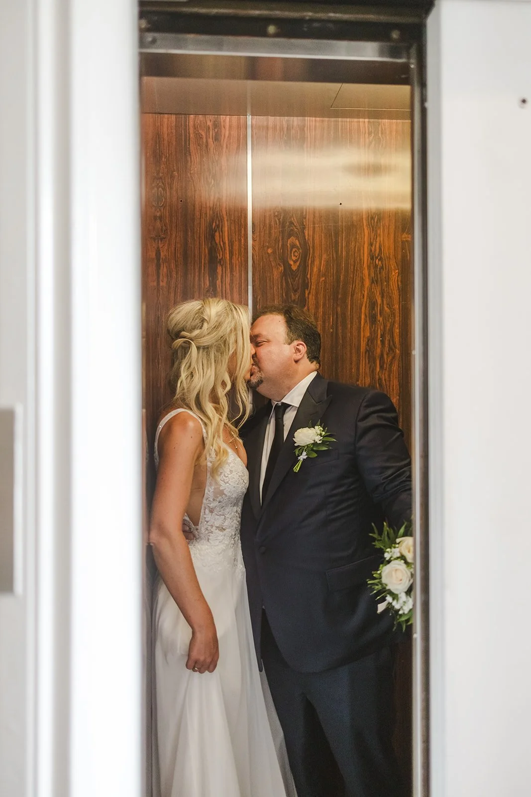 Bride and groom kiss in elevator  London, ON  Fedora Media.jpg
