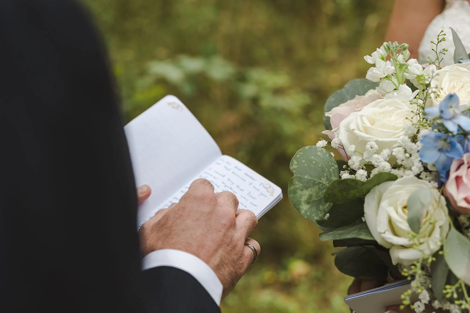 Groom with vow book and hand details  Carmen's Hotel  Hamilton, ON  Fedora Media.jpg