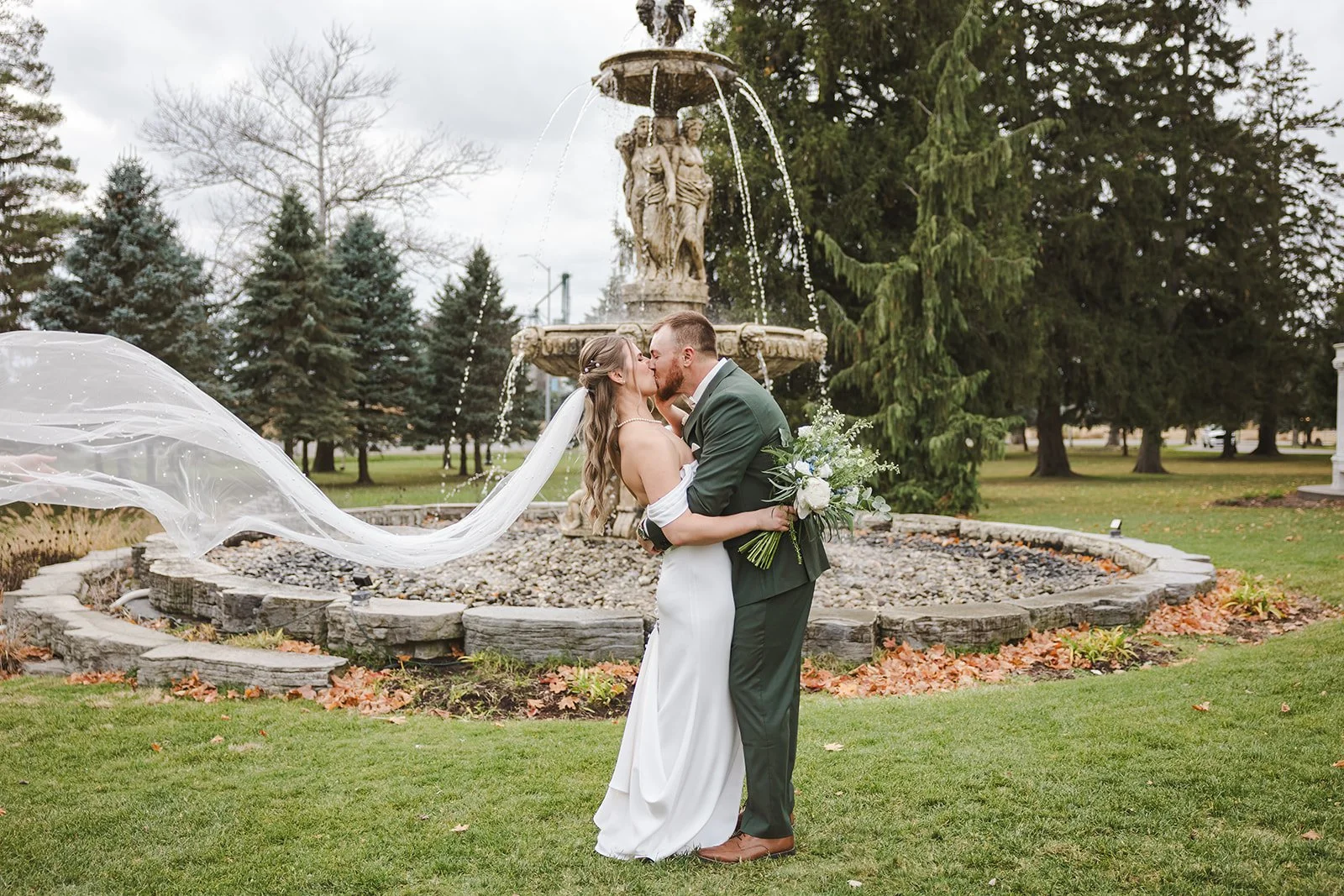 Bride and groom kiss with veil in the wind  fall wedding  Fedora Media.jpg