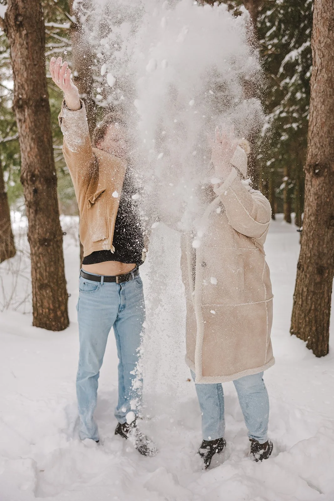 Couple throwing snow in forest  Ontario Engagement  Fedora Media.jpg