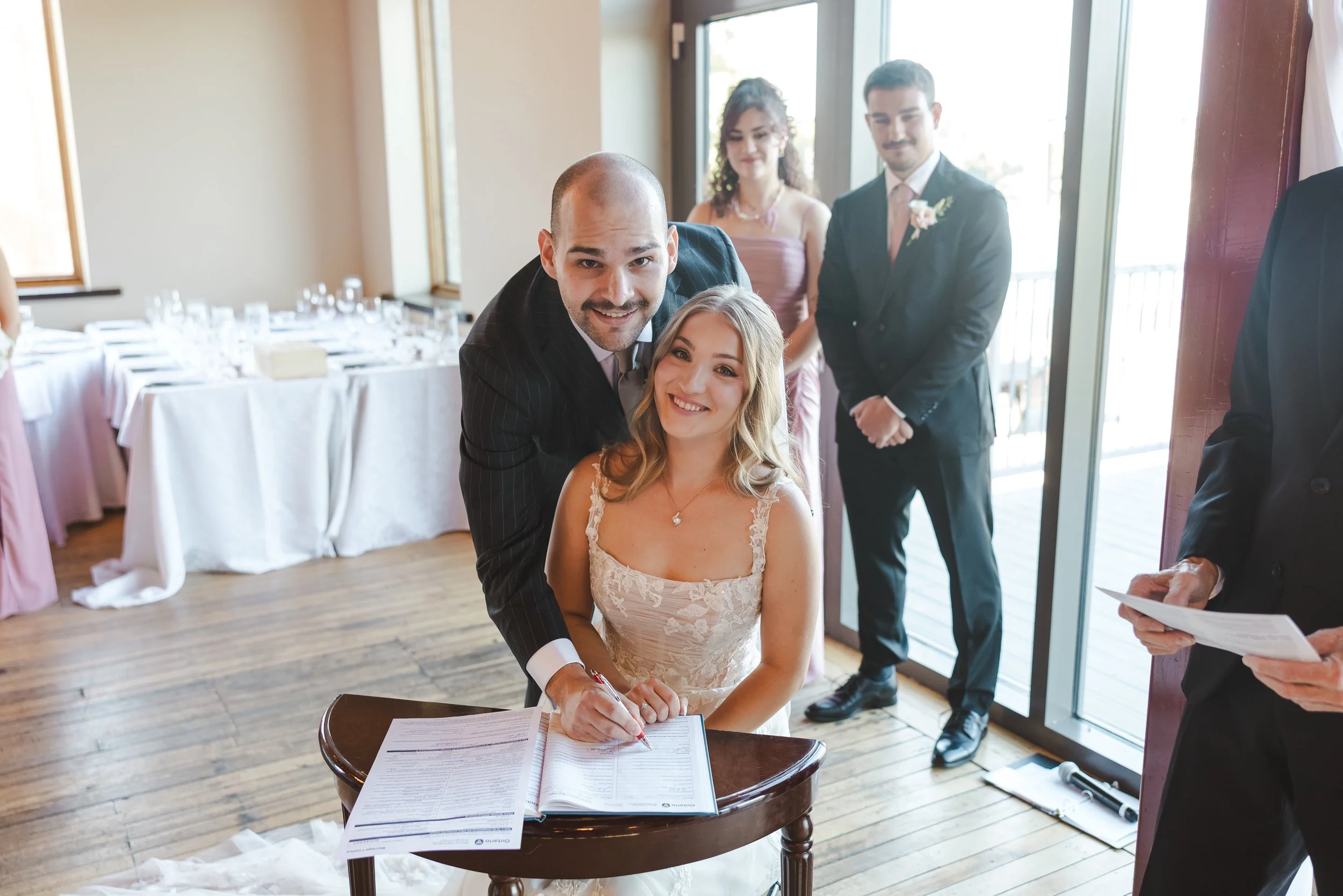 couple-signing-papers-at-wedding-fedora-media.jpg