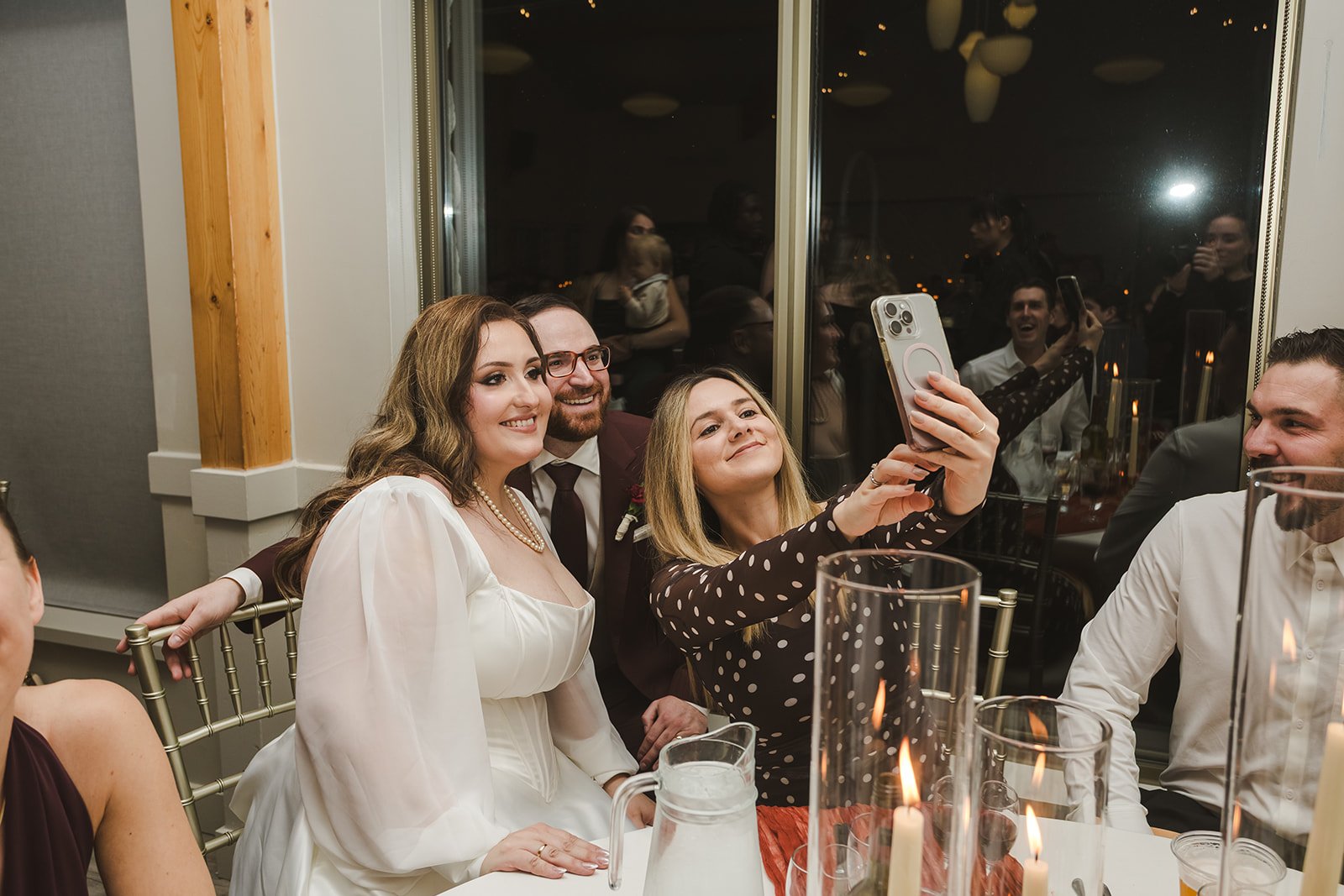 Guests taking selfies with bride and groom  Lakeview By Carmens  Hamilton, ON  Fedora Media.jpg