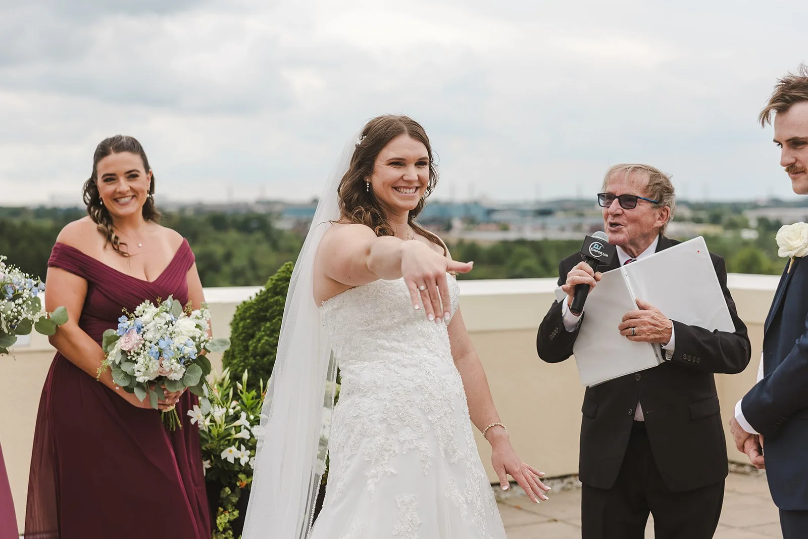 Bride shows wedding ring to guests during ceremony  Carmen's Hotel  Hamilton, ON  Fedora Media.jpg