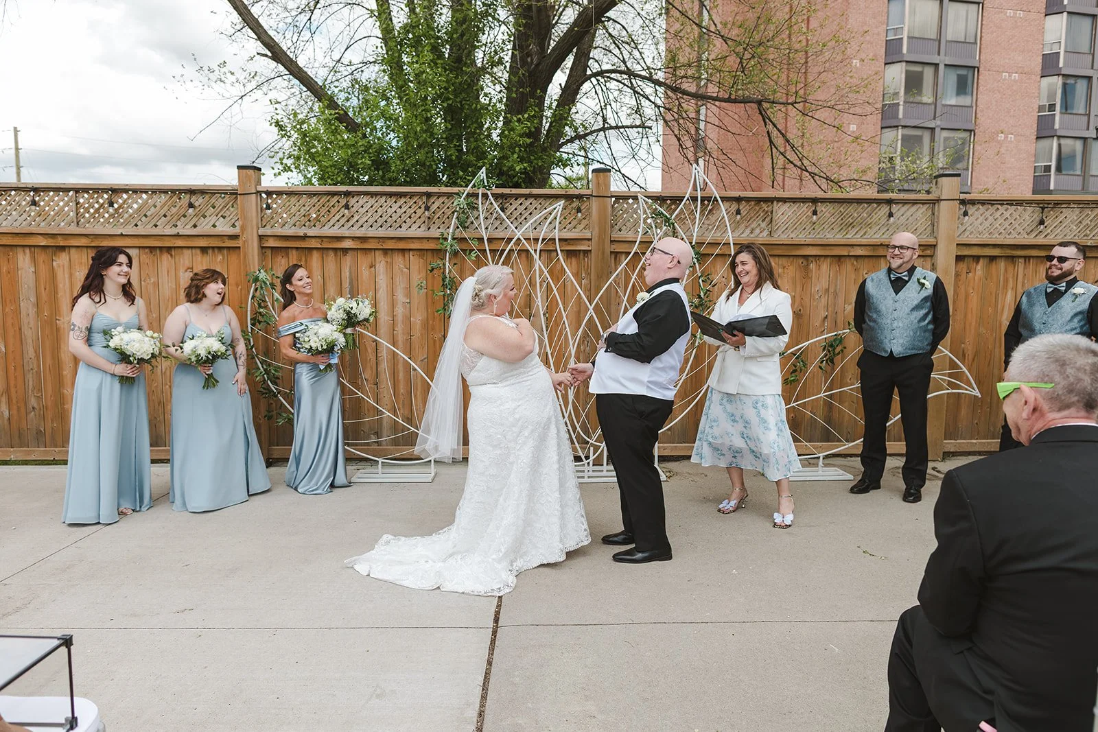 Bride and Groom share a laugh during wedding ceremony  Cambridge Hotel  Cambridge, ON  Fedora Media.jpg