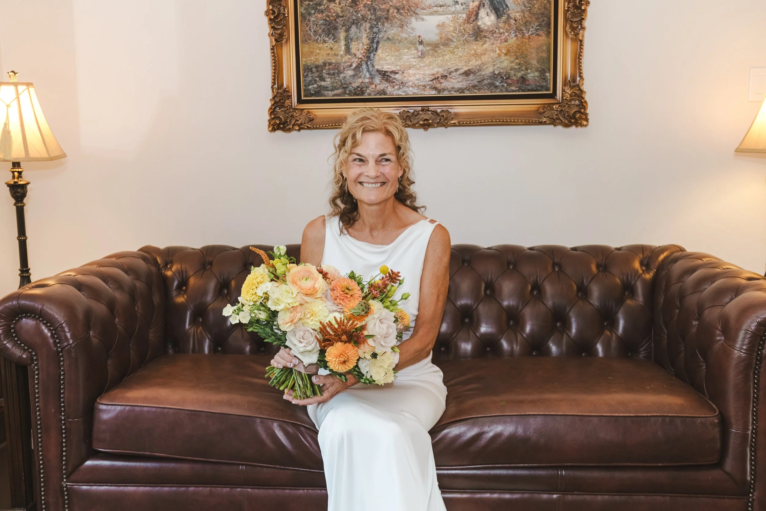 bride-sitting-on-leather-couch-fedora-media.jpg