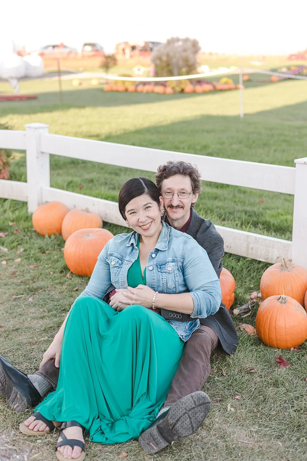 Couple sitting with pumpkins  Ontario Engagement  Fedora Media.jpg
