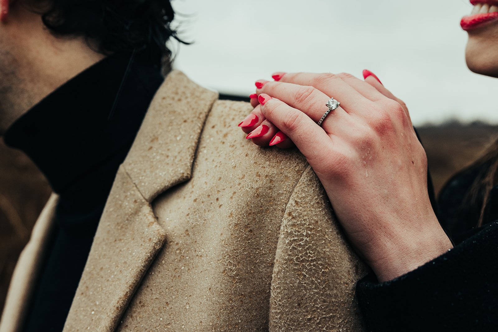 Hands on shoulder with engagement ring  Fedora Media.jpg