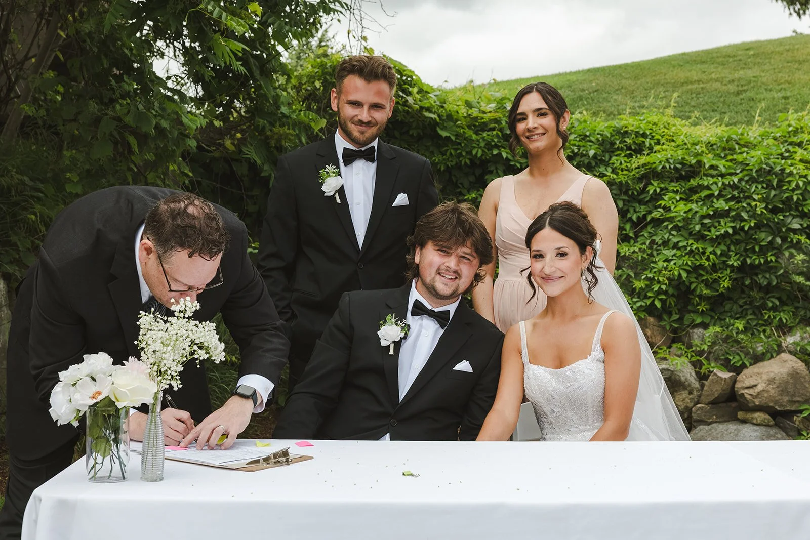Bride and groom at signing table  Rebel Creek  Fedora Media.jpg
