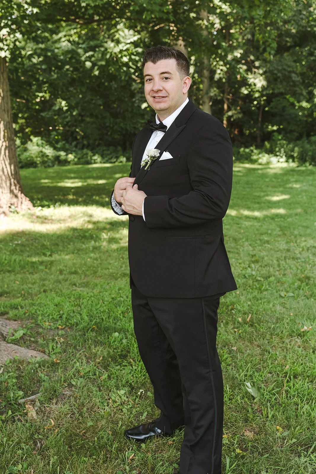 Groom doing up suit jacket  Arlington Hotel  River's Edge  Paris, ON  Fedora media.jpg