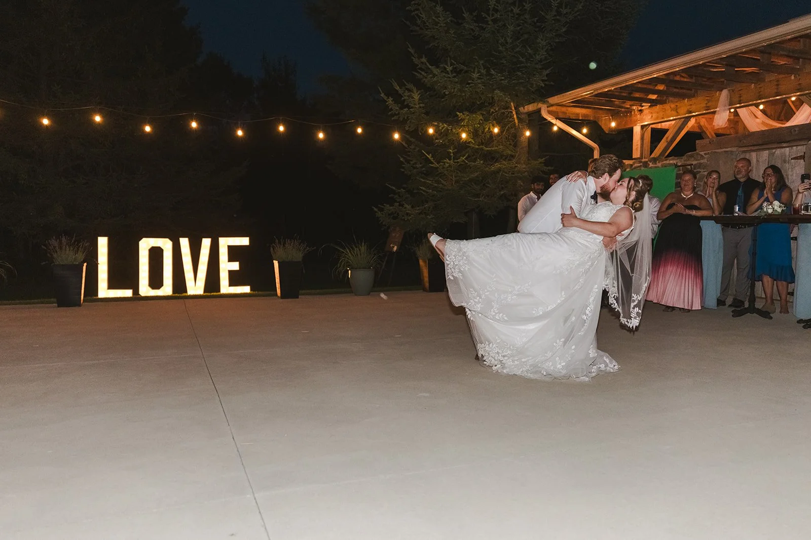 Bride and groom dip kiss during first dance  CJ Country events  Guelph, ON  Fedora Media.jpg