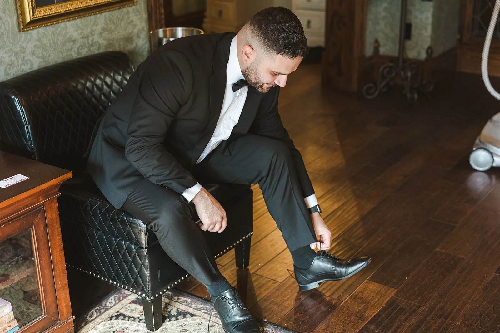 Groom tying shoes  Erin Estates  Fedora Media.jpg