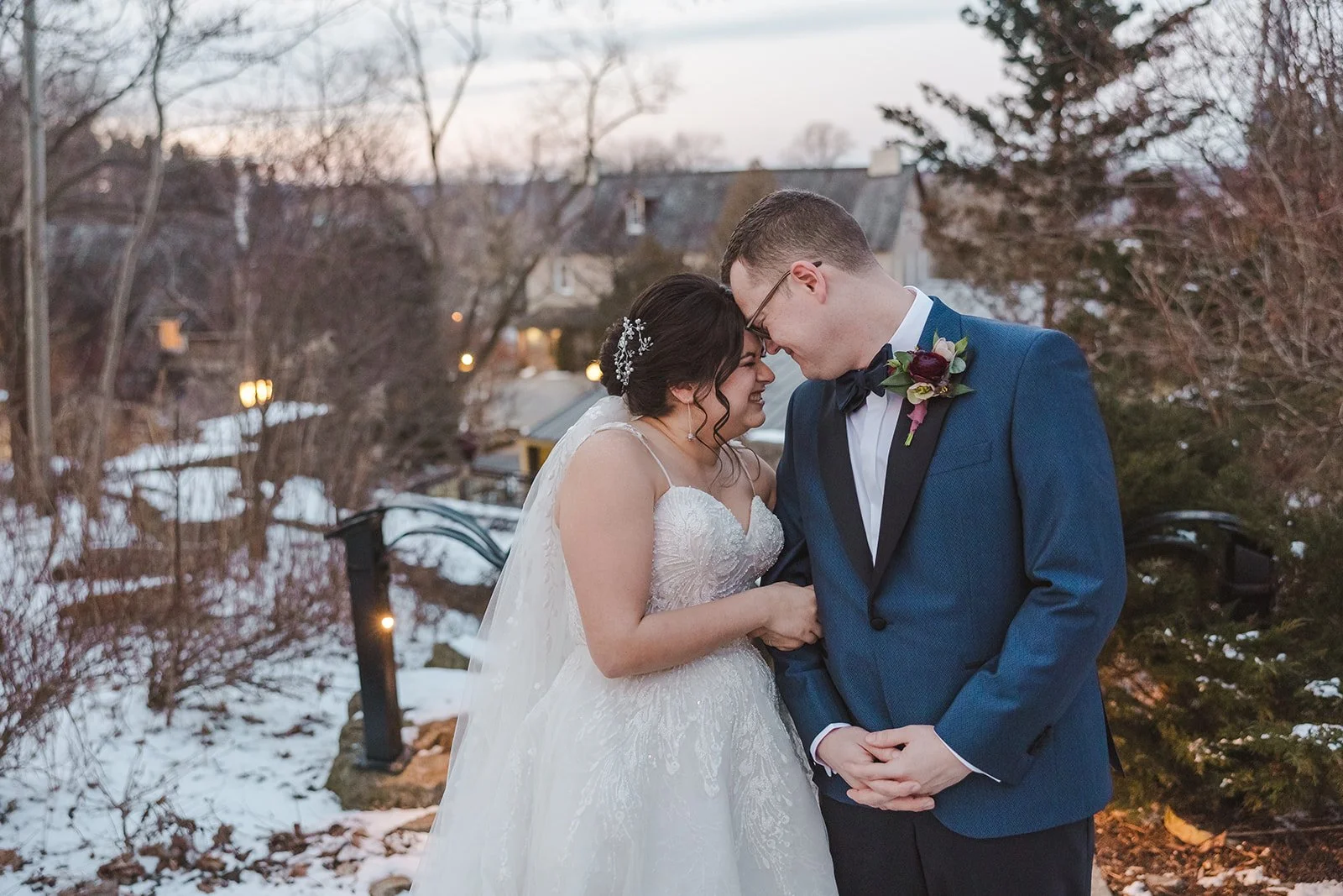 Bride and groom embrace by touching foreheads in snow  Ancaster,  ON  Ancaster Mill  Fedora Media.jpg