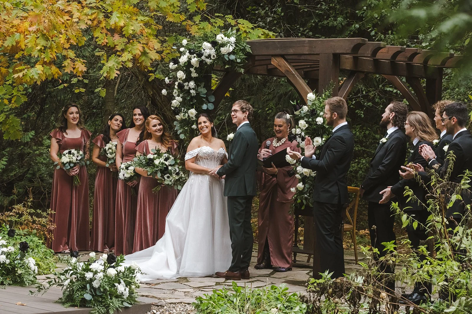 Bride and groom with wedding party and officiant at altar facing guests  Erin Estates  Fedora Media.jpg
