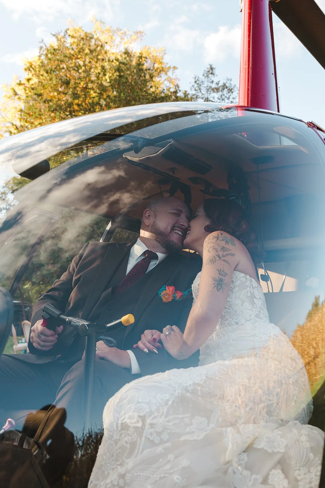 Bride and Groom Pilot and co-pilot smiling embrace  Great Lakes Helicopters  Fedora Media.jpg