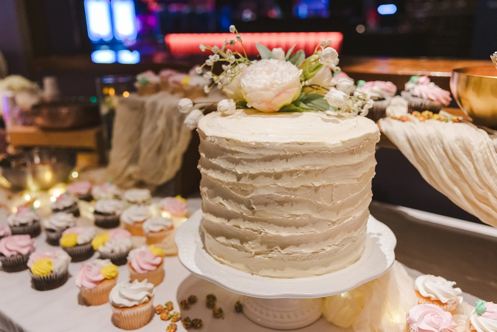 White weddng cake with flowers  bowling alley wedding Fedora Media..jpg